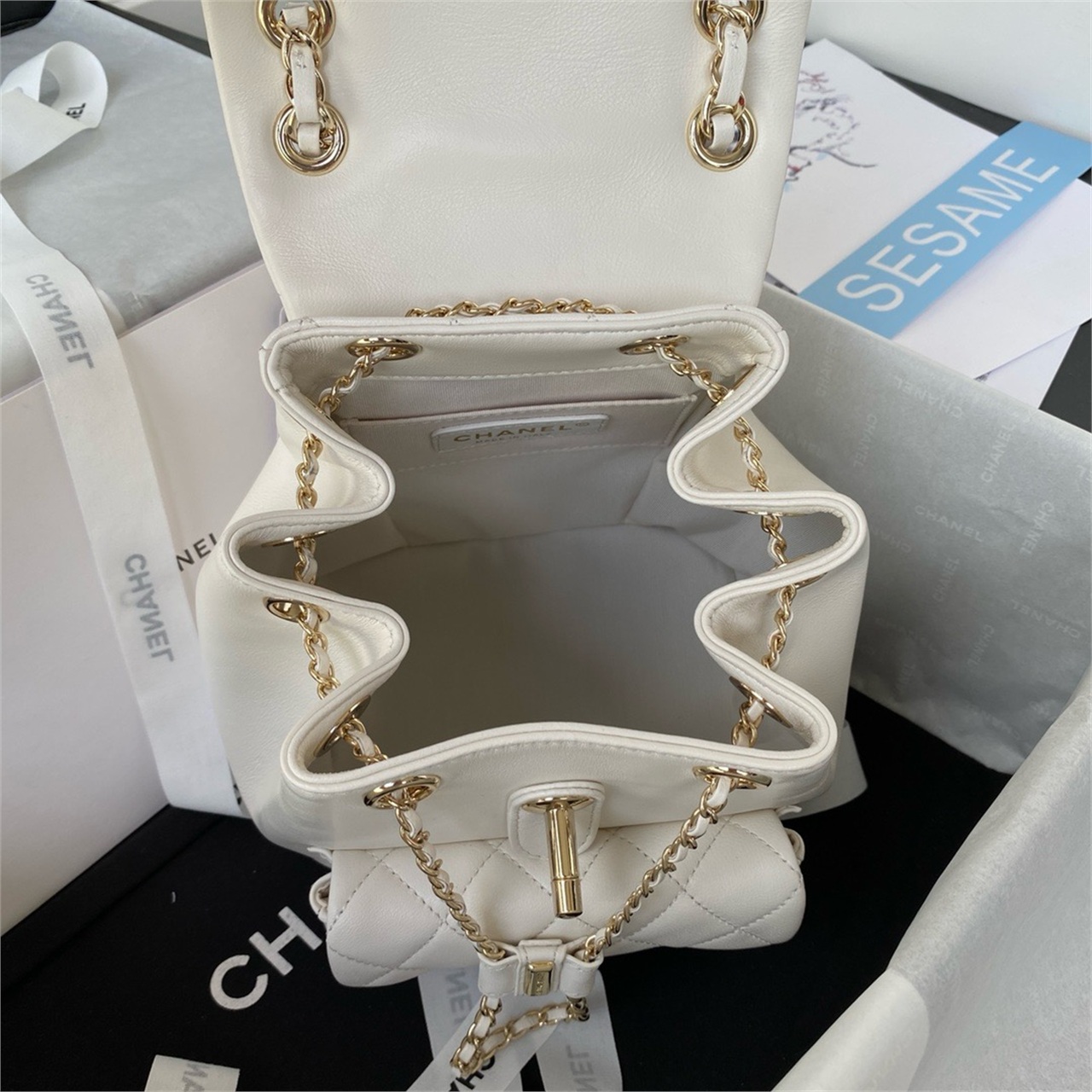 CHANEL beige lambskin diamond grid mini backpack